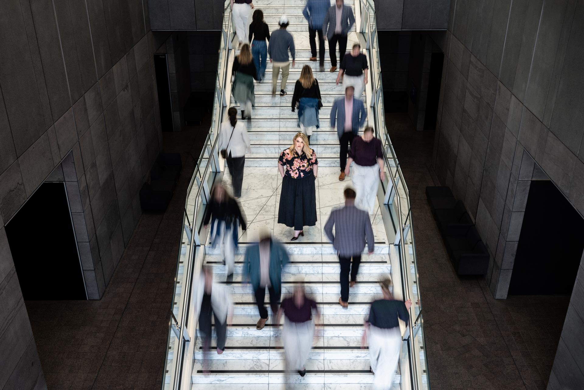 Crowd moving down wide city stairs