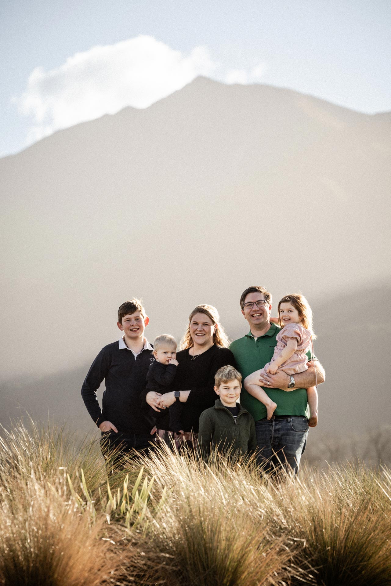 Camille, Chris and their four children in a field at Whakahā
