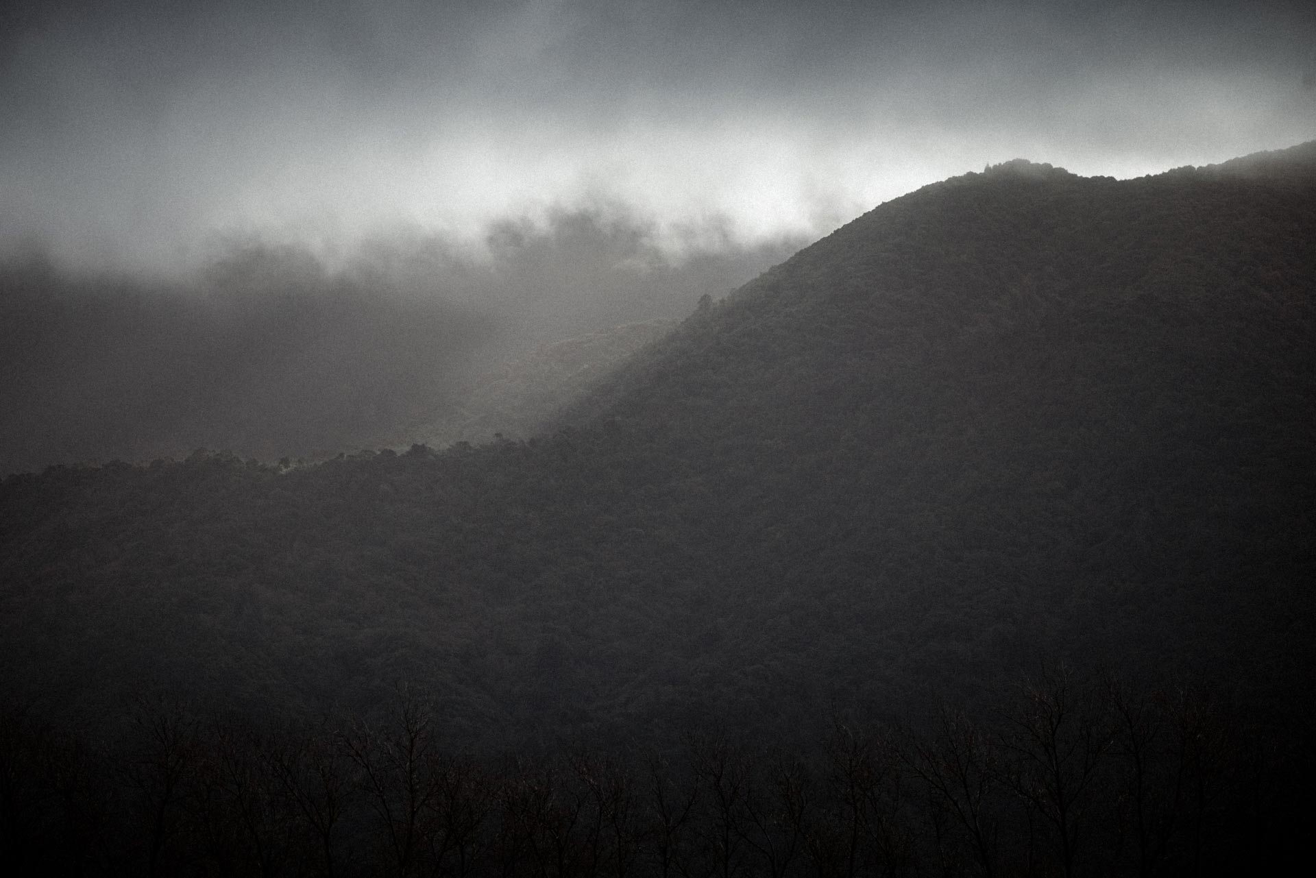 A close up of Mt Peel with Moody clouds drifting in front of and around it.