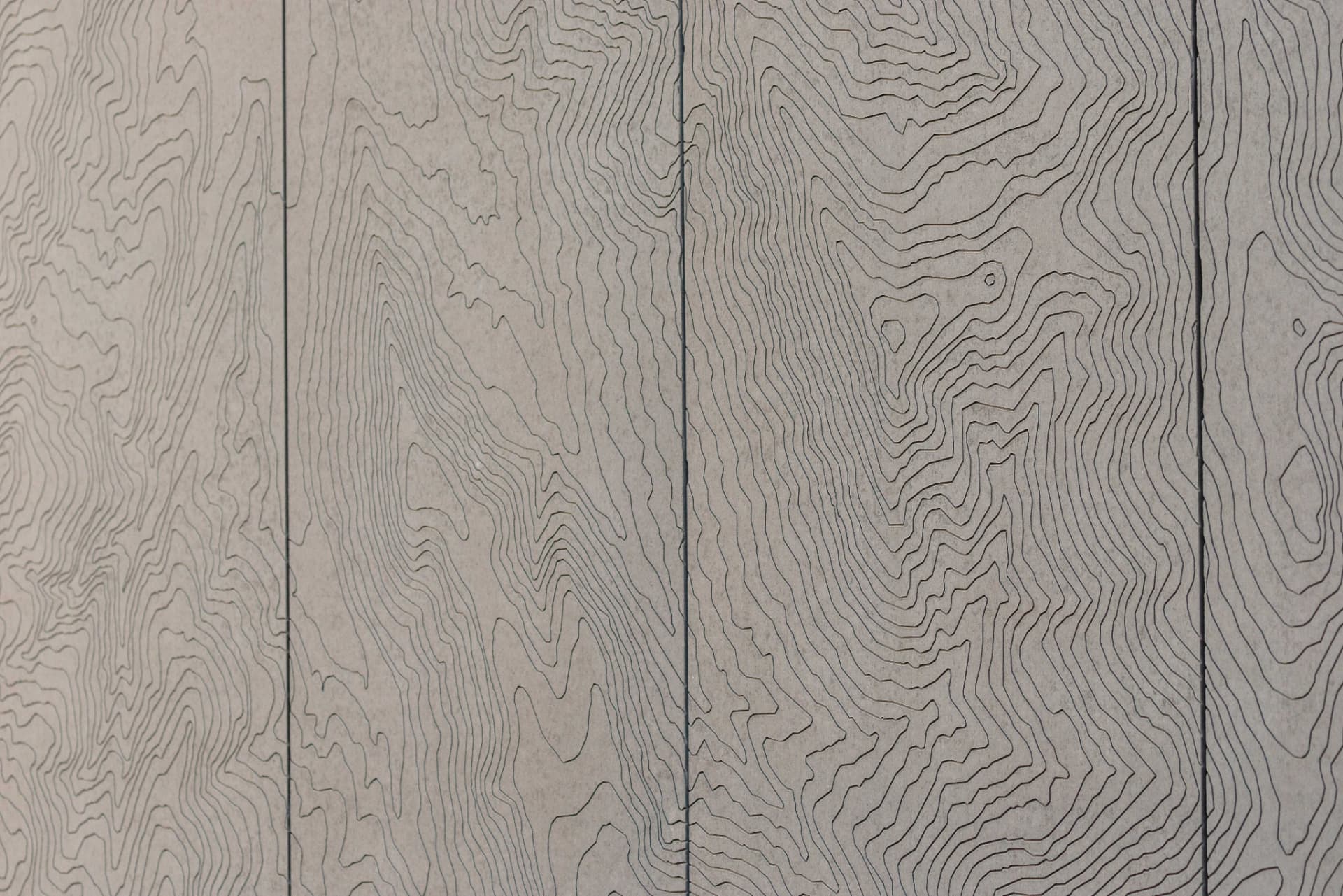 Grey stone panels engraved with contour lines